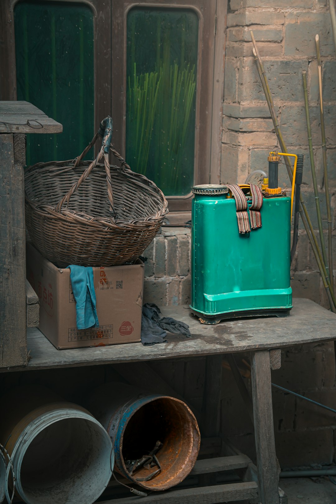 green-sprayer-and-basket-on-a-rustic-shelf-ymwhxzpqrdk